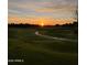 Picturesque golf course at sunset, featuring rolling green hills, a paved path, and a tranquil, scenic view at 11633 N 40Th Way, Phoenix, AZ 85028