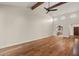 Expansive living room with vaulted ceilings, wood beams, hardwood floors, and a view of the kitchen and entryway at 11633 N 40Th Way, Phoenix, AZ 85028