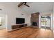 Bright and airy living room with stone fireplace, vaulted ceilings, and hardwood floors with access to the outdoors at 11633 N 40Th Way, Phoenix, AZ 85028