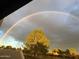 Vibrant rainbow over lush landscaping, with homes nestled in the background at 11633 N 40Th Way, Phoenix, AZ 85028