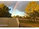 Scenic view of the lush golf course and homes capped off by a vibrant rainbow in the distance at 11633 N 40Th Way, Phoenix, AZ 85028