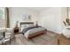 Bedroom featuring a bed, two side tables with lamps and art on the walls at 11702 W Lincoln St, Avondale, AZ 85323