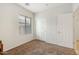 Comfortable bedroom with a closet, window, and neutral carpet flooring to enhance a cozy feel at 11702 W Lincoln St, Avondale, AZ 85323