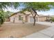 Angle view of home featuring neutral stucco, low maintenance landscaping, and a spacious driveway at 11702 W Lincoln St, Avondale, AZ 85323