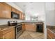 Kitchen with stainless steel oven, microwave, wood cabinets, tile floor and dishwasher at 11702 W Lincoln St, Avondale, AZ 85323