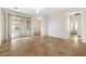 Spacious living room with tile flooring and a sliding glass door to the covered patio at 11702 W Lincoln St, Avondale, AZ 85323