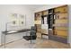 Modern office space featuring a sleek desk, an ergonomic chair, and stylish built-in shelving at 11702 W Lincoln St, Avondale, AZ 85323