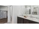 Elegant bathroom with a double sink vanity, marble countertop, and neutral decor at 11948 E Aster Ln, Florence, AZ 85132