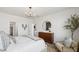 Bright bedroom with a modern chandelier, stylish dresser, and a comfortable bed at 11948 E Aster Ln, Florence, AZ 85132