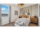 Stylish bedroom featuring electric guitars, a decorative trunk, and a window letting in natural light at 11948 E Aster Ln, Florence, AZ 85132