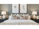 Close-up of a bedroom showcasing decorative pillows and framed art above the bed at 11948 E Aster Ln, Florence, AZ 85132