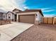 Charming single-story home with a spacious driveway and low-maintenance desert landscaping for relaxed living at 11948 E Aster Ln, Florence, AZ 85132