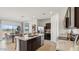 Open kitchen and dining area with a large island and sliding glass doors at 11948 E Aster Ln, Florence, AZ 85132