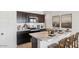Stylish kitchen featuring stainless steel appliances and a marble island with seating at 11948 E Aster Ln, Florence, AZ 85132