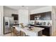 Modern kitchen with stainless steel appliances and a breakfast bar at 11948 E Aster Ln, Florence, AZ 85132