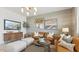 Comfortable living room with stylish decor, a large brown sofa, and neutral tones at 11948 E Aster Ln, Florence, AZ 85132