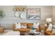 Welcoming living room showcasing a comfortable brown sofa, and decorative wall art at 11948 E Aster Ln, Florence, AZ 85132