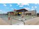 Outdoor splash pad featuring colorful play structures and lounge chairs, perfect for Gathering fun in a community setting at 11948 E Aster Ln, Florence, AZ 85132