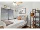 Cozy bedroom featuring a ceiling fan, rustic decor, and ample natural light for a relaxing atmosphere at 13320 N 82Nd Dr, Peoria, AZ 85381