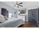 Comfortable bedroom with ceiling fan, slider door to back yard, and a large safe at 13320 N 82Nd Dr, Peoria, AZ 85381