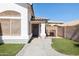 Beautiful property with manicured landscaping, and a gray front door with a decorative wreath at 13320 N 82Nd Dr, Peoria, AZ 85381