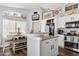 Open kitchen design featuring an island, breakfast bar, modern appliances, and ample countertop space at 13320 N 82Nd Dr, Peoria, AZ 85381