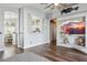 Stylish living room featuring wood floors, a pass-through window, and bright lighting at 13320 N 82Nd Dr, Peoria, AZ 85381
