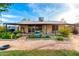 Spacious backyard with a covered patio, lush landscaping, and mature trees at 1409 S Revere --, Mesa, AZ 85210