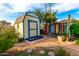 Well-maintained backyard shed with colorful painted fence, and lush trees at 1409 S Revere --, Mesa, AZ 85210