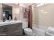 Clean bathroom featuring a single vanity, toilet, and a shower over tub at 1409 S Revere --, Mesa, AZ 85210