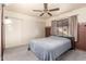 Comfortable bedroom with carpet, a ceiling fan, and a sliding closet at 1409 S Revere --, Mesa, AZ 85210
