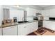 Well-lit kitchen with white cabinets, granite countertops, and stainless steel appliances at 1409 S Revere --, Mesa, AZ 85210