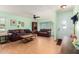 Inviting living room featuring wood-look floors, a ceiling fan, and comfortable seating at 1409 S Revere --, Mesa, AZ 85210