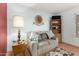Cozy sitting area with a comfortable couch, lamp, and hardwood floors at 1409 S Revere --, Mesa, AZ 85210