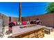 Backyard lounge area with fire pit, seating, and hardscape at 15427 W Port Au Prince Ln, Surprise, AZ 85379
