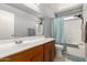 Bright bathroom features a vanity with wood cabinets, shower with tub, and great lighting at 15427 W Port Au Prince Ln, Surprise, AZ 85379