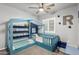 Fun bedroom with built-in bed, ceiling fan and bright window at 15427 W Port Au Prince Ln, Surprise, AZ 85379