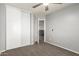 Neutral bedroom with carpet, closet, and adjacent room entrance at 15427 W Port Au Prince Ln, Surprise, AZ 85379
