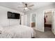 Bedroom with gray walls, carpeted floor, ceiling fan, and closet access at 15427 W Port Au Prince Ln, Surprise, AZ 85379