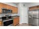 Bright kitchen featuring stainless steel appliances, modern cabinets, and a side-by-side stainless steel refrigerator at 15427 W Port Au Prince Ln, Surprise, AZ 85379
