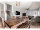 Open-concept living room with dining area and staircase, featuring neutral colors and a mounted television at 15427 W Port Au Prince Ln, Surprise, AZ 85379