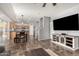 Open-concept living space with tiled floors connecting the kitchen, dining, and living areas at 15427 W Port Au Prince Ln, Surprise, AZ 85379