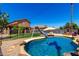 Backyard pool featuring a slide, desert landscaping and nearby seating at 15427 W Port Au Prince Ln, Surprise, AZ 85379