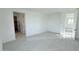 Spacious bedroom with soft carpet, white walls and doors to an en-suite bathroom at 15634 W Hackamore Dr, Surprise, AZ 85387