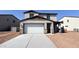 Charming two-story home with a two-car garage and stone-accented pillars at 15634 W Hackamore Dr, Surprise, AZ 85387