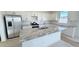 Bright kitchen featuring an island with granite countertops and stainless steel appliances at 15634 W Hackamore Dr, Surprise, AZ 85387