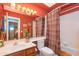 Bathroom with a large mirror, bright sconce lighting, and vanity with storage at 17342 E Quail Ridge Dr, Fountain Hills, AZ 85268