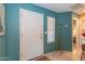 Inviting entryway featuring teal walls, a white front door, and a unique vintage coat rack at 17342 E Quail Ridge Dr, Fountain Hills, AZ 85268
