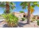 Beautiful desert landscape with palm trees surrounding a home featuring neutral tones and well-manicured shrubbery at 17342 E Quail Ridge Dr, Fountain Hills, AZ 85268