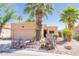 Charming tan home featuring desert landscaping, vibrant cacti, and a mature palm tree at 17342 E Quail Ridge Dr, Fountain Hills, AZ 85268